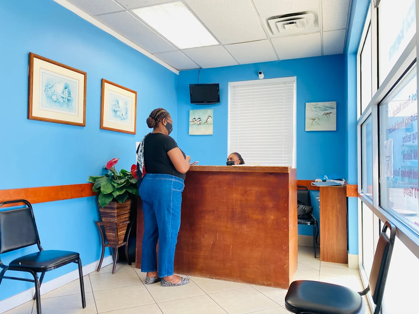 AccuDiagnostics reception desk in Providenciales, with staff helping a patient at check-in.