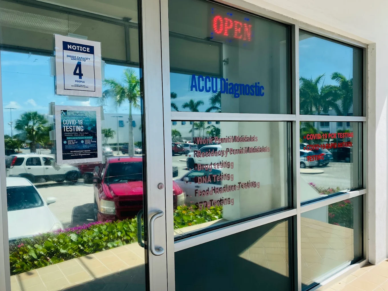 AccuDiagnostics storefront entrance — glass door with the AccuDiagnostics signage and an OPEN sign visible.